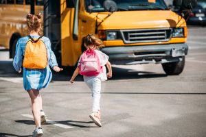 rear-view-of-schoolgirls-with-backpacks-running-to-2024-11-19-14-48-21-utc-300x200