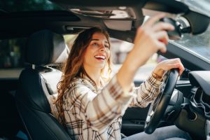 happy-smiling-woman-inside-a-car-driving-in-the-st-2025-02-24-20-49-37-utc-300x200